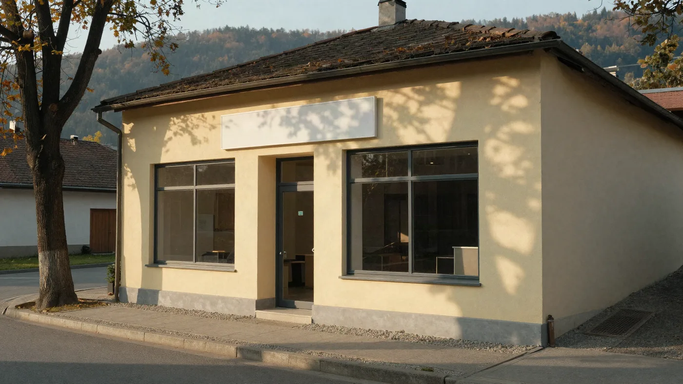 The office from the street, with the wooded hills of the Balaton uplands behind it